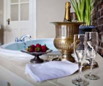 hot tub in hotel with strawberries and glasses for champagne