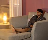 woman relaxes in spa by heat lamp