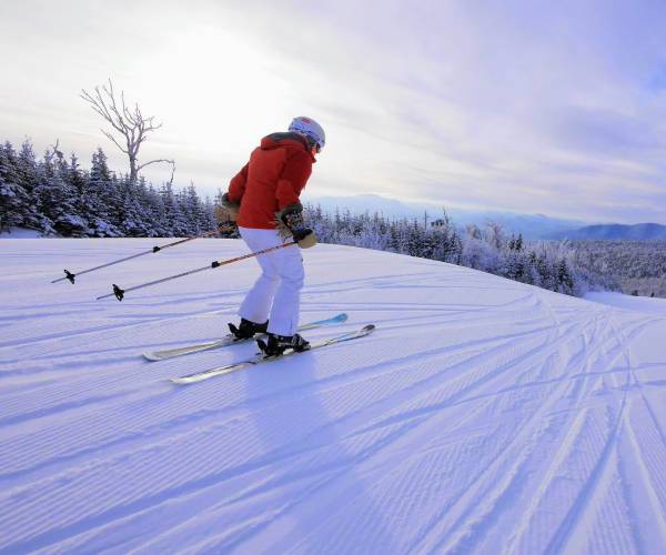 downhill skier with red jacket