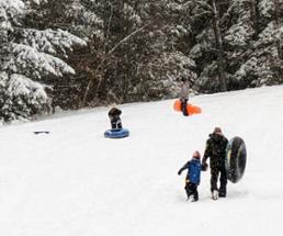 people on snow tubing hill