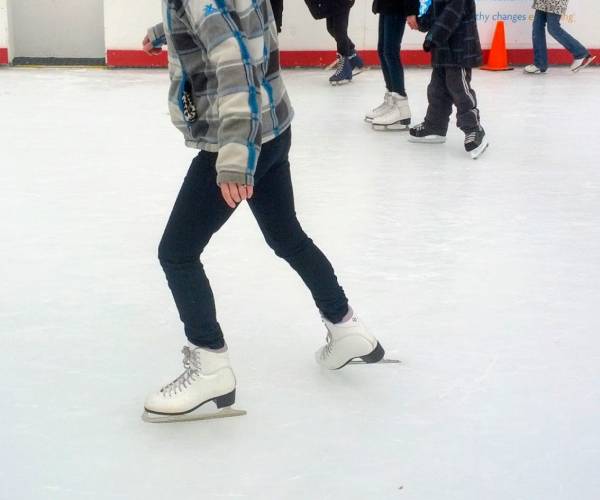 close up of people ice skating