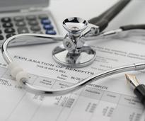 insurance statement, stethoscope, pen, and calculator