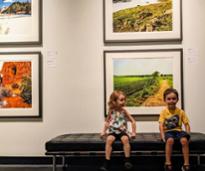 kids at hyde museum sit by paintings