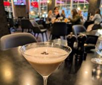 chocolate martini in foreground, people in background