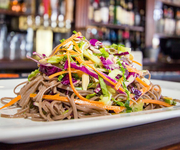 a plate of noodles with cabbage