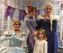 little girl poses with princesses