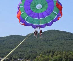 people parasailing over lake george