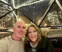 couple pose in dining igloo