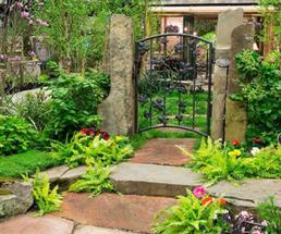 green garden with fancy gate entrance