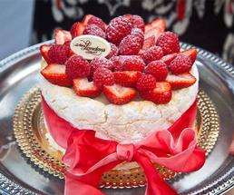 a cake with raspberries and strawberries