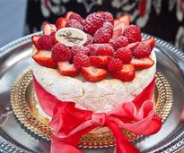 a cake with raspberries and strawberries