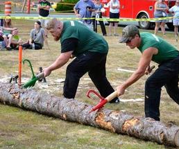 two men cutting a log