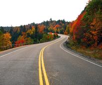 road through fall foliage mountains