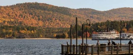 people on village docks taking photos of fall foliage