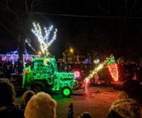 tractor parade with a tractor decorated with holiday lights