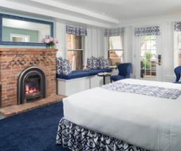 hotel room with a fireplace near the bed