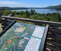 fort ticonderoga sign with view of lake champlain behind it