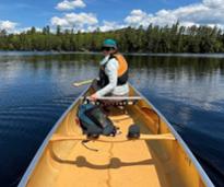 person in canoe in the adirondacks