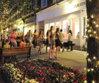 people on broadway in saratoga at dusk