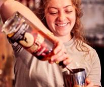 woman pours a drink