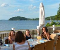 women dining by saratoga lake