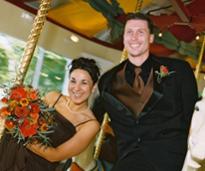 groomsman and bridesmaid pose on congress park carousel 