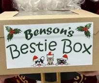 closeup of santa holding a benson's pet center bestie gift box