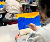 woman painting in class