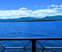 view of lake and mountains from deck
