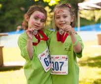 two girls holding up race medals