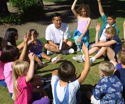 kids sitting in a circle at summer camp