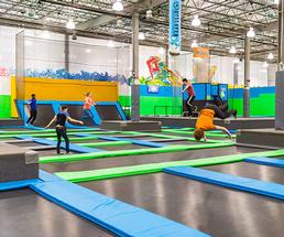 people in an indoor trampoline park