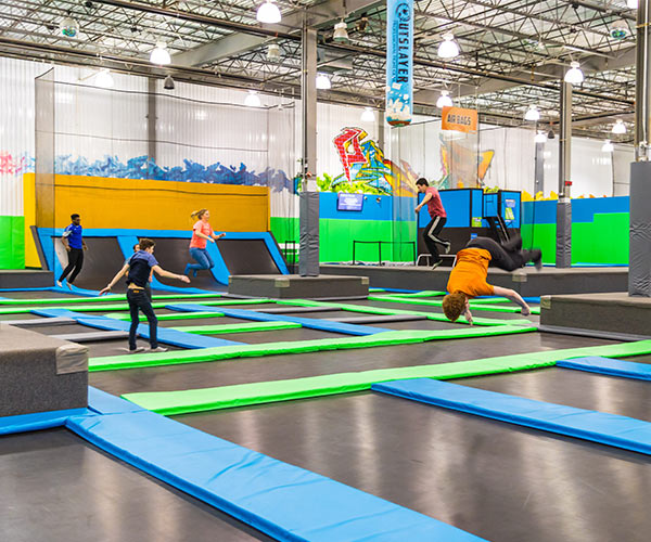 people in an indoor trampoline park
