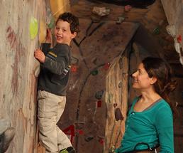 boy on an indoor rock wall