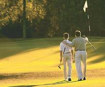 male teen and father on golf course