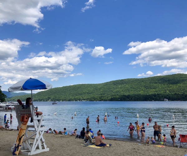 families at a beach in Lake George