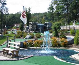 a mini golf course with a fountain and waterfall