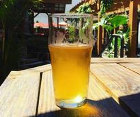 a glass of beer on a table at a beer garden