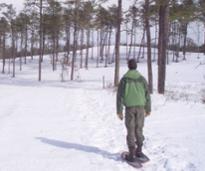 snowshoer in green jacket