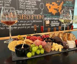wine glasses and cheese board on a table