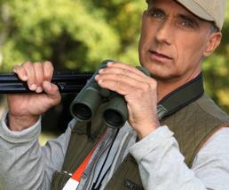 hunter with gun and binoculars