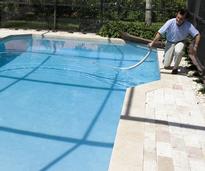 person cleaning a pool