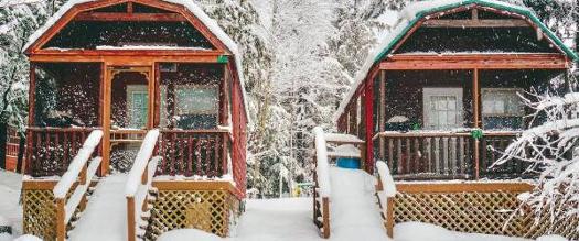 two snowy cabins