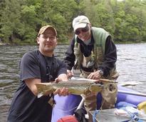 two men holding a fish