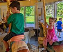 kids on congress park carousel