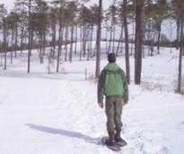 a snowshoer standing on snowy ground