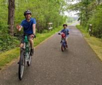 dad and kid biking on warren county bikeway
