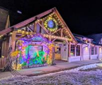 lake george visitors center in the winter decorated with lights