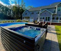 backyard of house rental with pool and hot tub