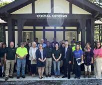 crowd poses in front of coesa spring